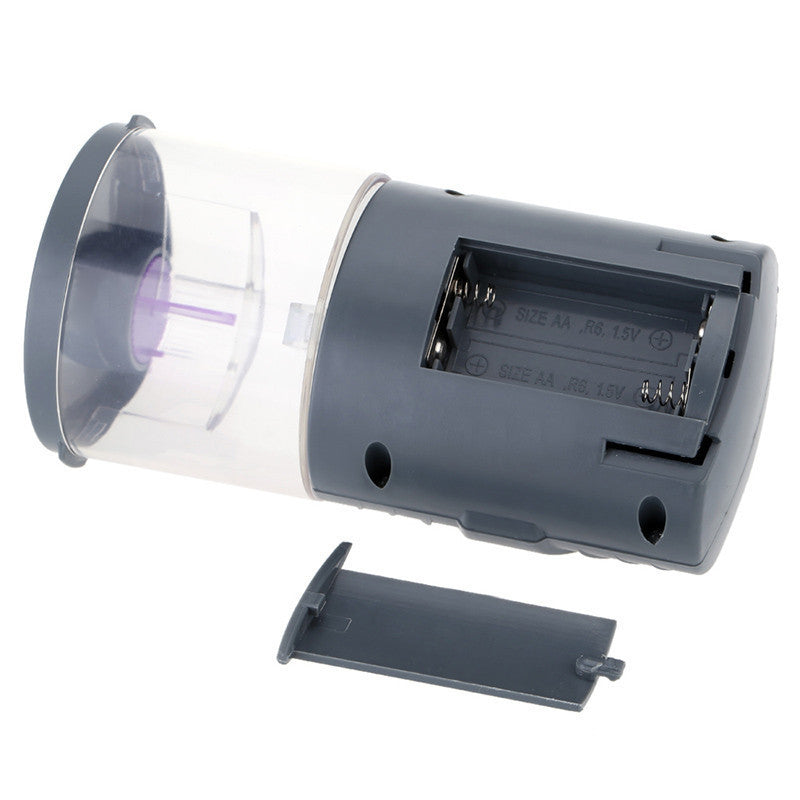 Intelligent timing fish feeder for aquarium device showing battery compartment and transparent food container.