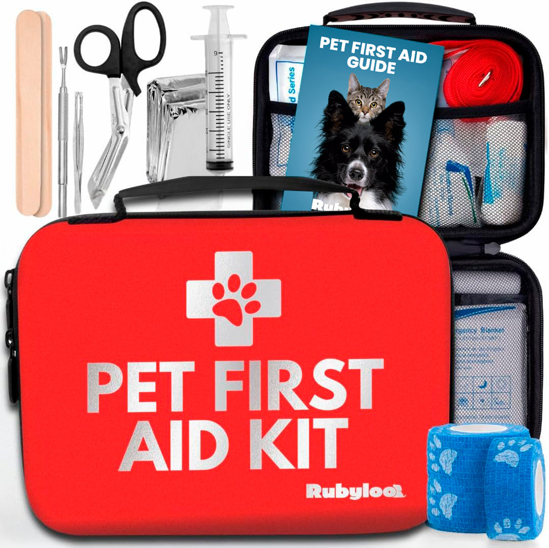 Pet first aid kit with various supplies including a red case, bandages, and a syringe.