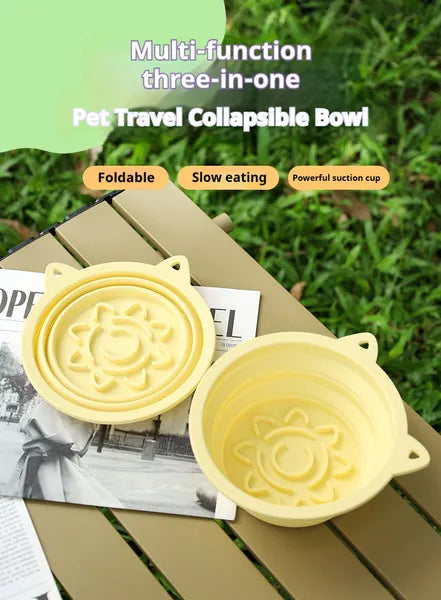 Two yellow pet travel collapsible bowls on a wooden surface with grass in the background.