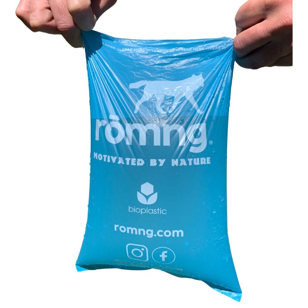 Blue bioplastic bag held by hands with 'romng' branding on a white background