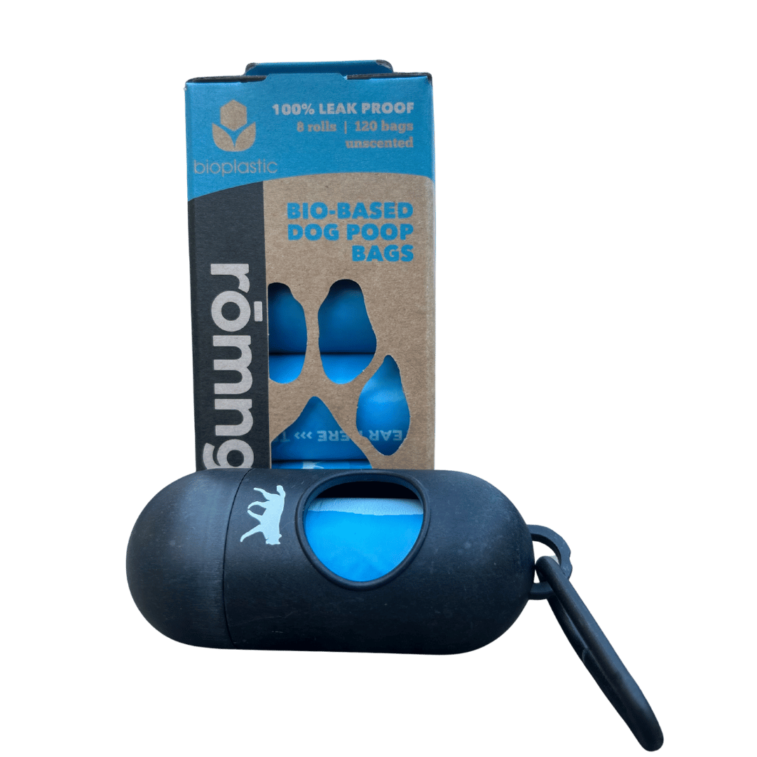 Dog poop bag dispenser with biodegradable bags packaging on a green background